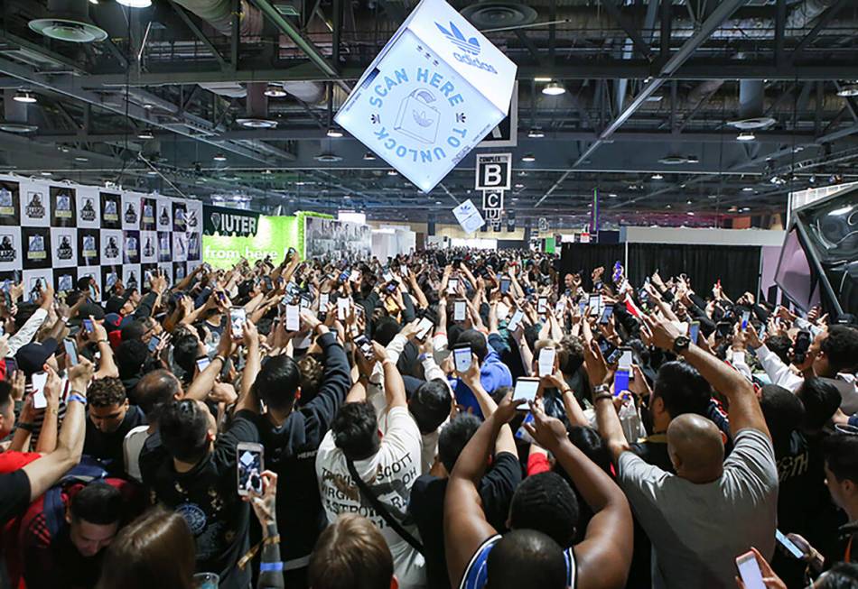 Attendees use their phones to scan an adidas activation at a previous year's edition of Complex ...