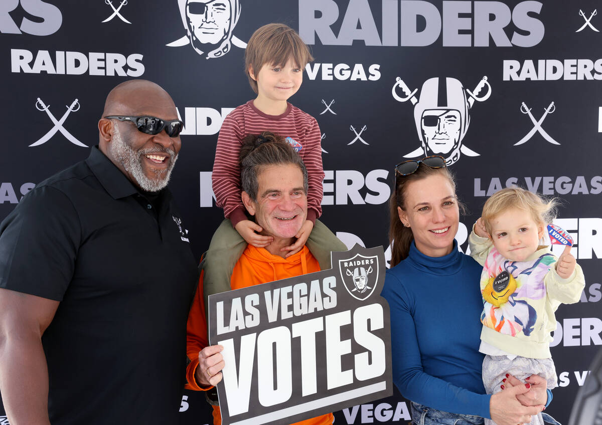 Raiders alumnus Roy Hart, left poses with Stu Levy, his wife Annika Levy and their children Aid ...