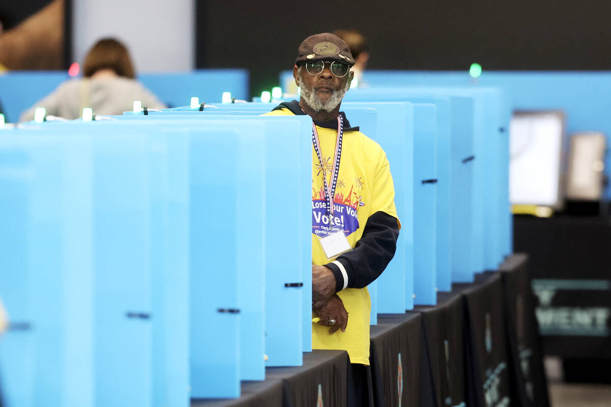 Poll workers help people cast their ballots at Allegiant Stadium in Las Vegas Tuesday, Nov. 5, ...