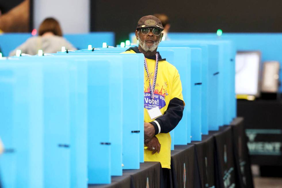 Poll workers help people cast their ballots at Allegiant Stadium in Las Vegas Tuesday, Nov. 5, ...