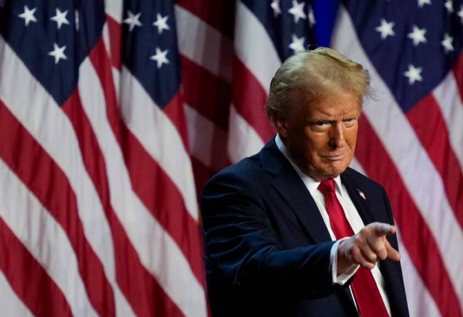 Donald Trump points to the crowd at an election night watch party, Wednesday, Nov. 6, 2024, in ...