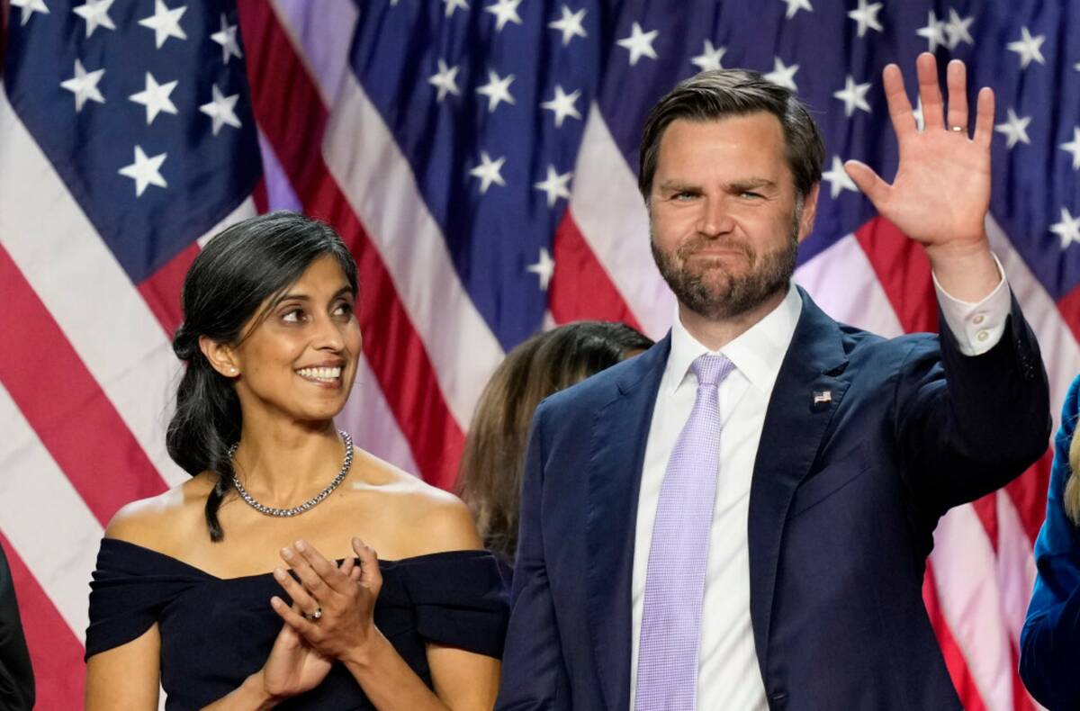 Sen. JD Vance, R-Ohio, waves as his wife Usha Vance looks on at an election night watch party, ...