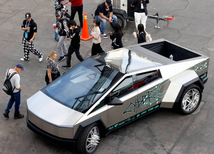 Attendees check out a Tesla Cybertruck on display during the first day of SEMA at the Las Vegas ...