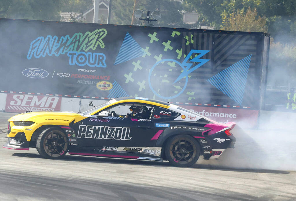 A professional driver puts on a tire slaying show at Hoonigan’s burn pit during the firs ...