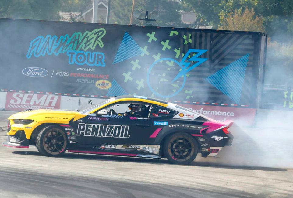 A professional driver puts on a tire slaying show at Hoonigan’s burn pit during the firs ...