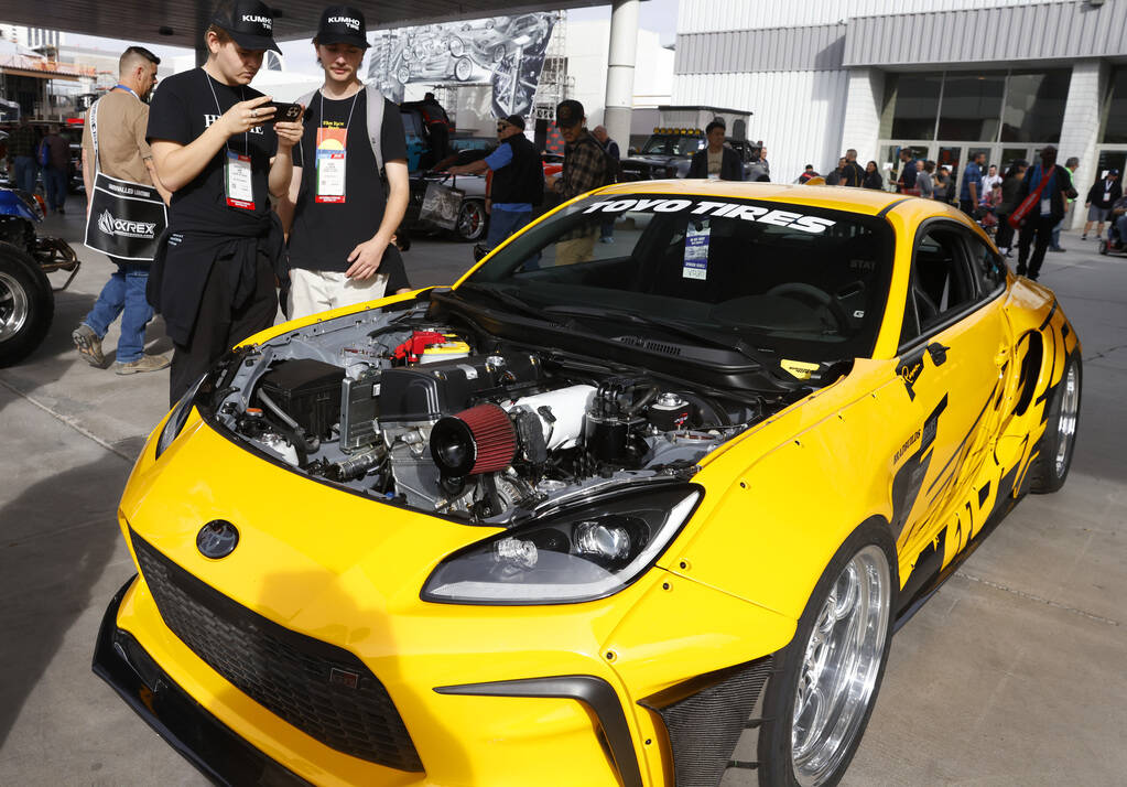 Attendees check out a 2023 Toyota GR86 during the first day of SEMA at the Las Vegas Convention ...