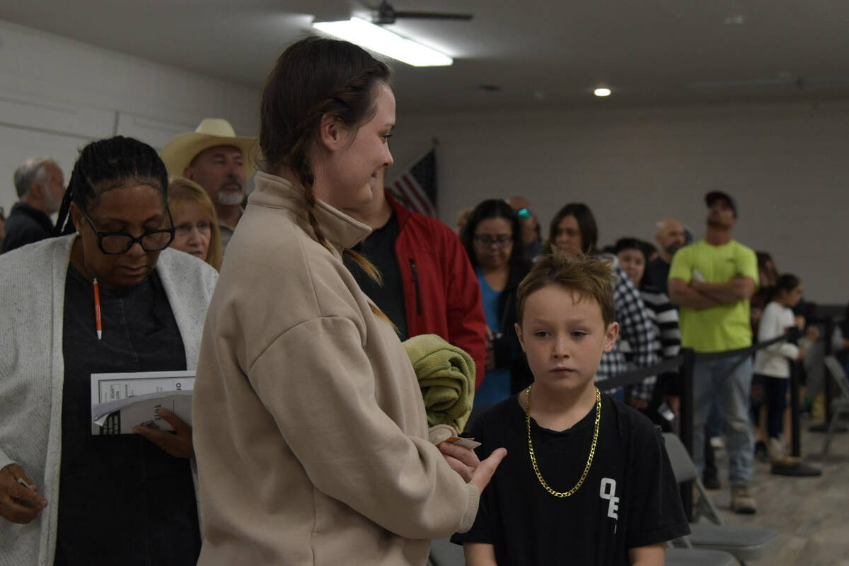 A non-eligible youth waits inside the Bob Rudd community center as voters wait up to three hour ...