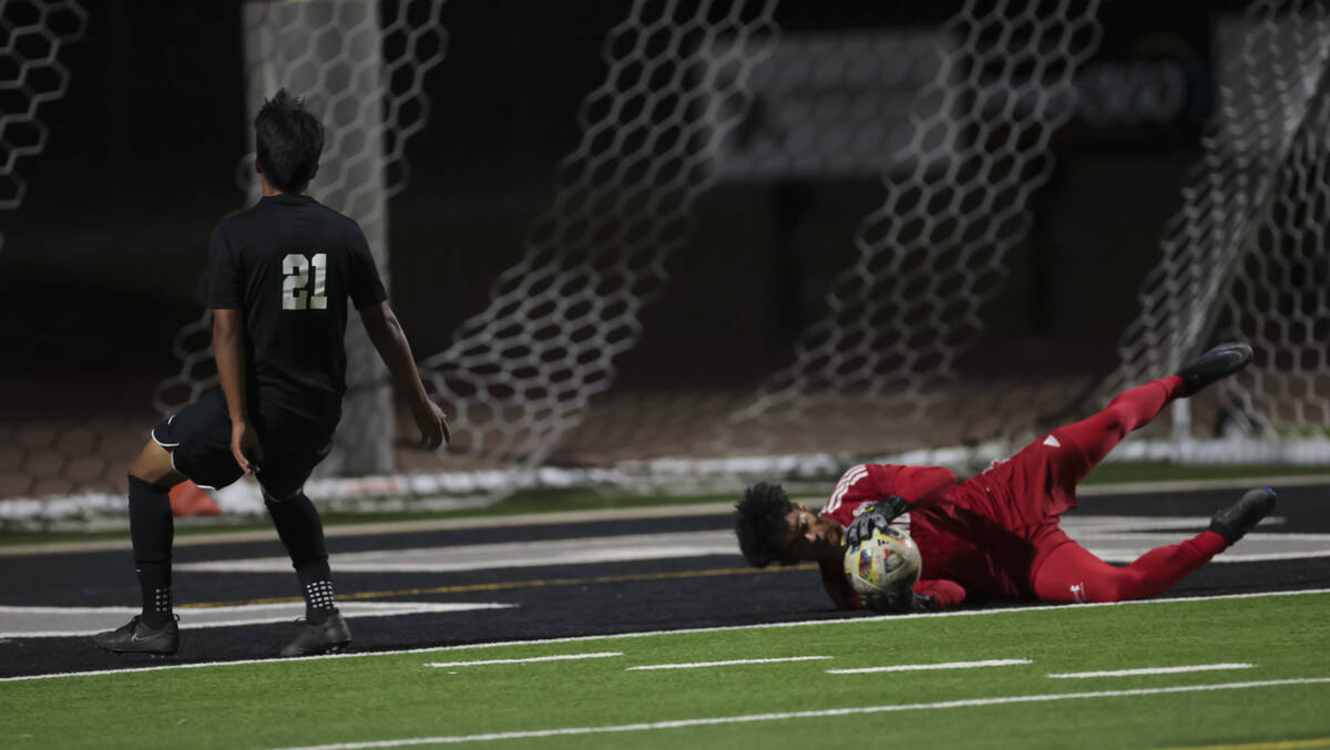 Coronado goalkeeper Logan Pierce stops the ball against Palo Verde’s Eric Rojas (21) dur ...