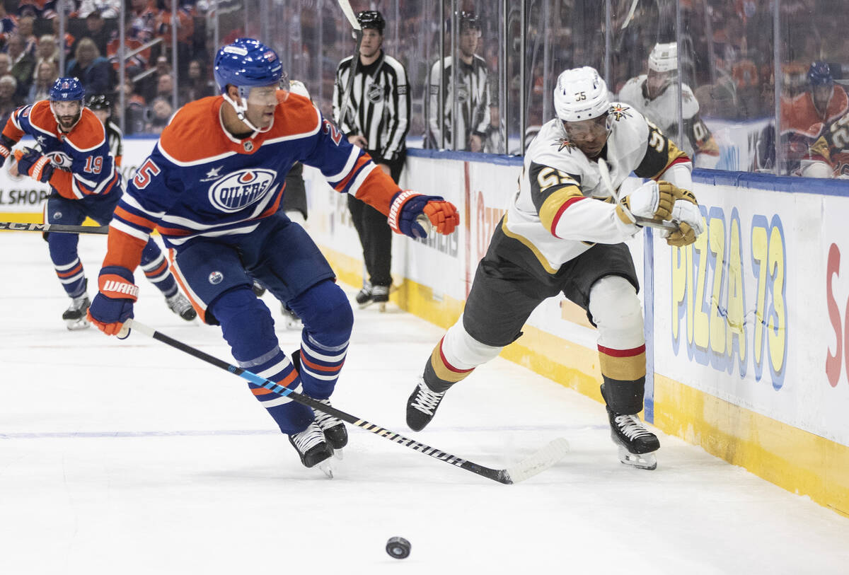 Vegas Golden Knights' Keegan Kolesar (right) and Edmonton Oilers' Darnell Nurse (25) race for t ...