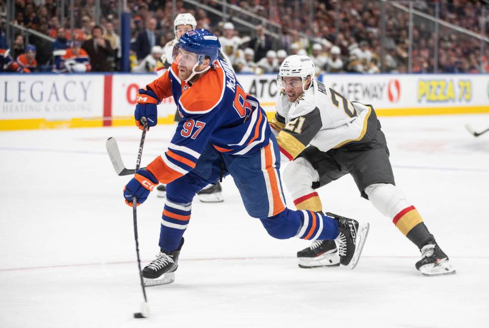 Vegas Golden Knights' Brett Howden (21) tries to defend against Edmonton Oilers' Connor McDavid ...