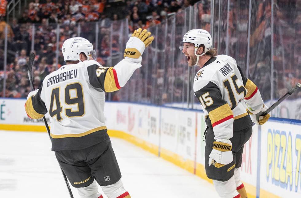 Vegas Golden Knights' Ivan Barbashev (49) and Noah Hanifin (15) celebrate a goal against the Ed ...