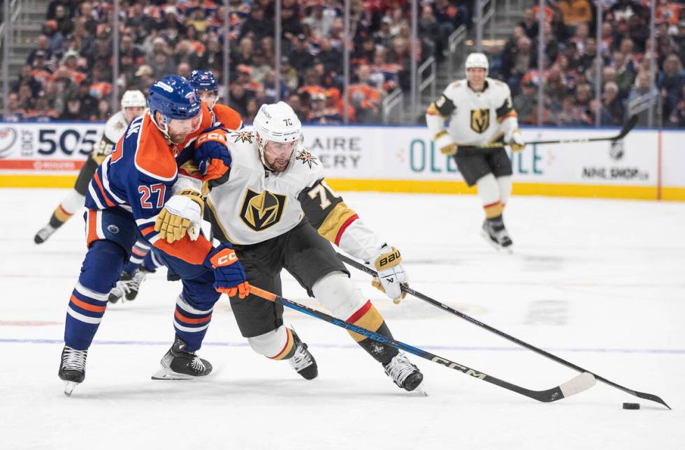 Vegas Golden Knights' Tanner Pearson (70) and Edmonton Oilers' Brett Kulak (27) battle for the ...