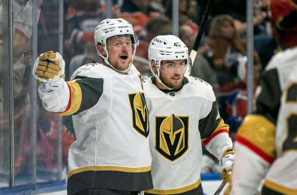 Vegas Golden Knights' Jack Eichel, left, and Ivan Barbashev (49) celebrate a goal against the E ...