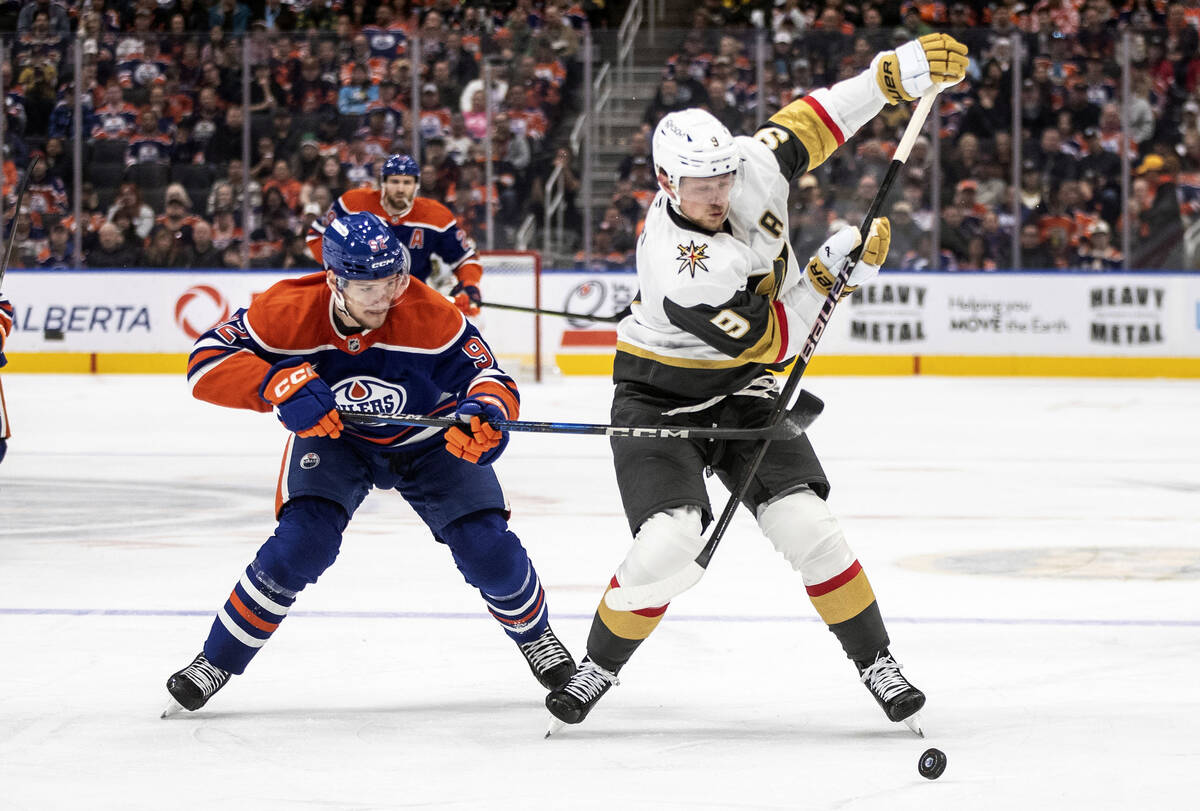 Vegas Golden Knights' Jack Eichel (9) and Edmonton Oilers' Vasily Podkolzin (92) battle for the ...