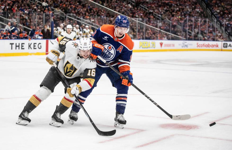 Vegas Golden Knights' Pavel Dorofeyev (16) and Edmonton Oilers' Ryan Nugent-Hopkins (93) battle ...