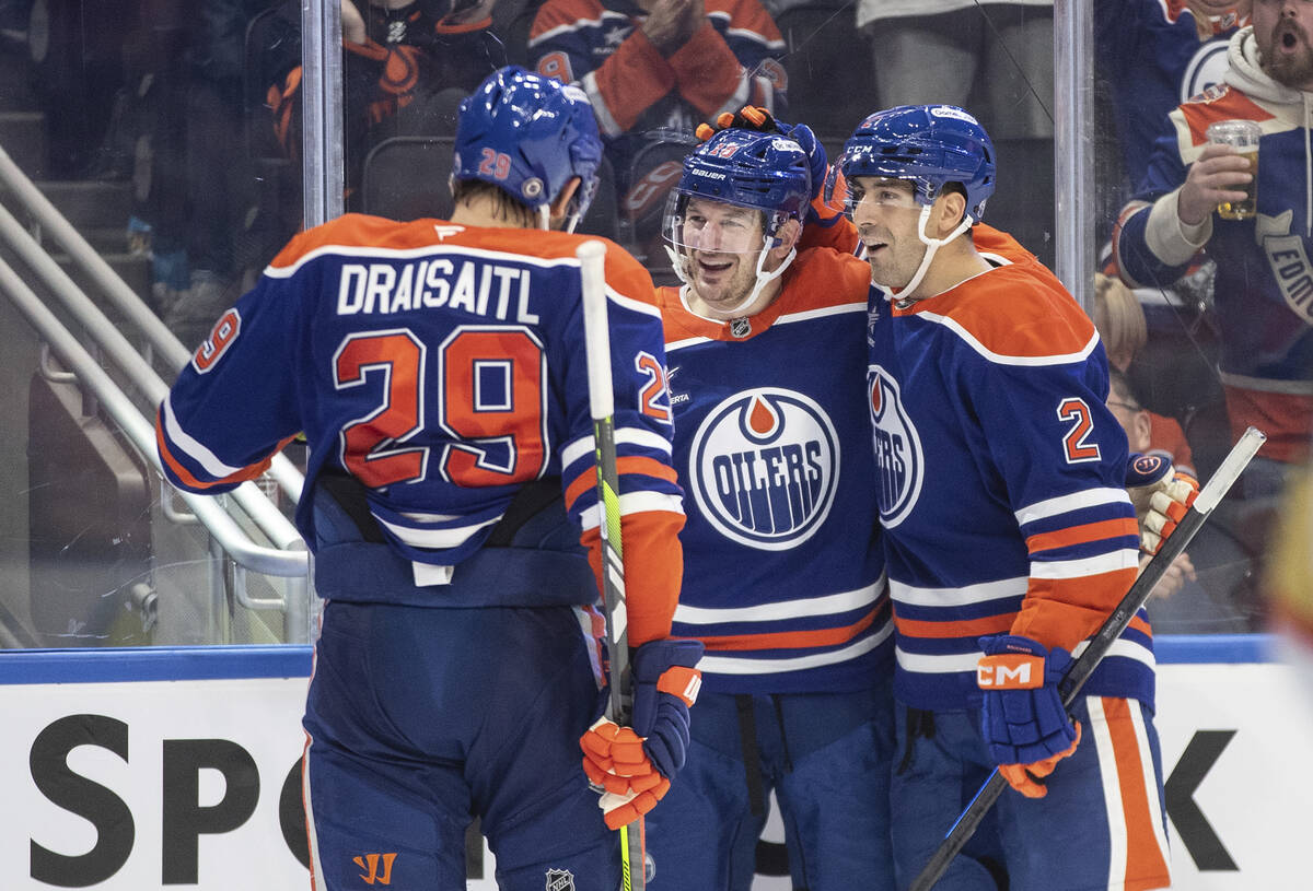 Edmonton Oilers' Leon Draisaitl (29), Zach Hyman (18) and Evan Bouchard (2) celebrate a goal ag ...