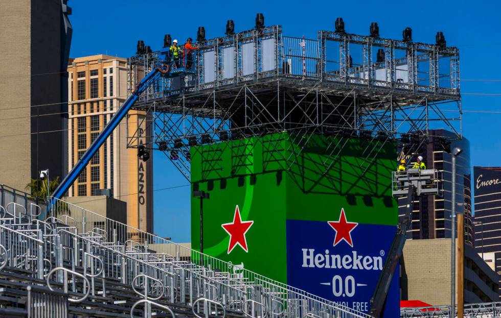 Workers complete a tower along Koval Lane as F1 infrastructure construction continues along the ...