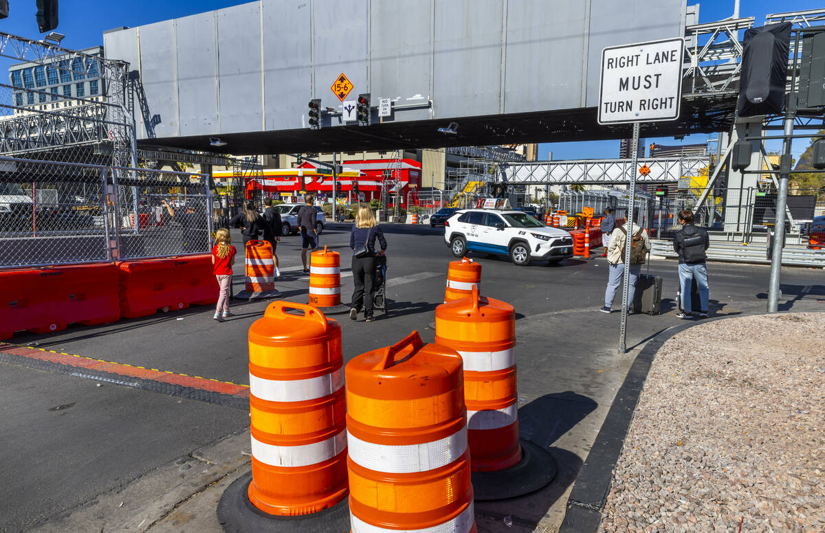 Pedestrians navigate barricades and other race barriers along Koval Lane at the Flamingo bridge ...