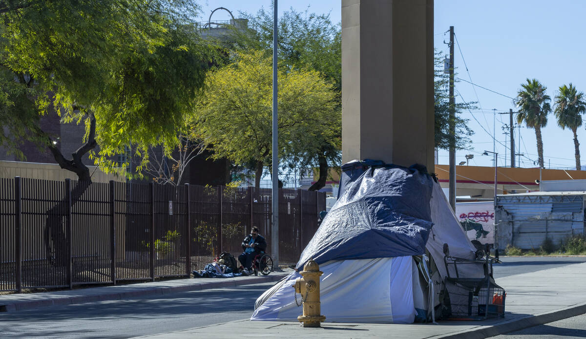 Homeless campers claim spots on the sidewalk along West Wilson Avenue on Wednesday, Nov. 6, 202 ...