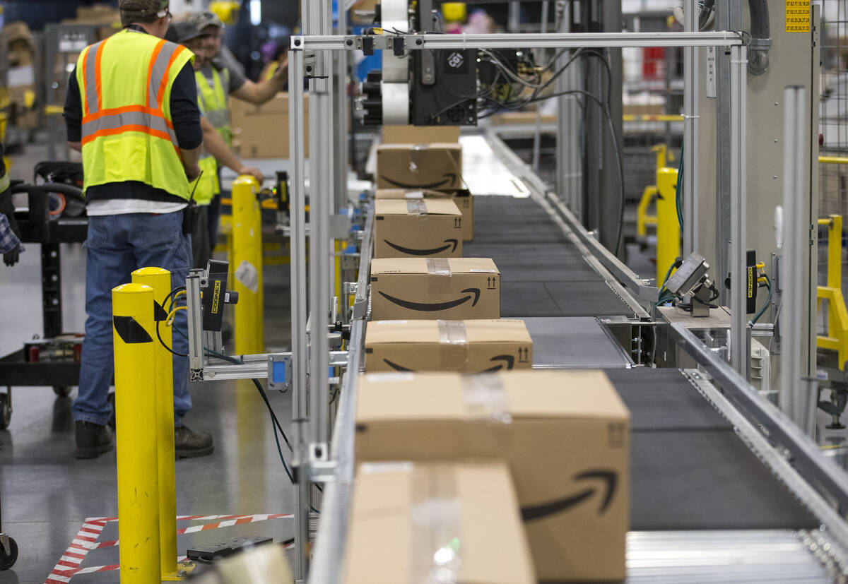 Boxes move down a conveyor belt during a tour of Amazon's North Las Vegas fulfillment center. A ...