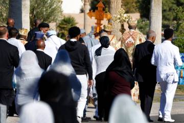 Mourners and Orthodox Church priests attend a burial service at Palm Eastern Mortuary and Cemet ...