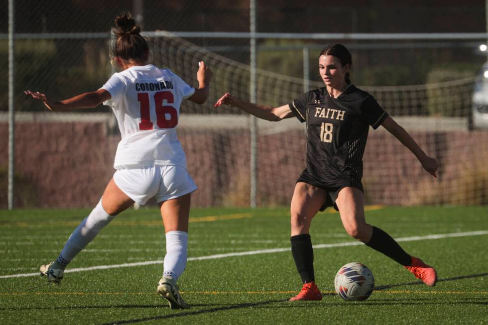 Faith Lutheran's Addison Jarvis (18) kicks the ball against Coronado's Mia Schlachter (16) duri ...