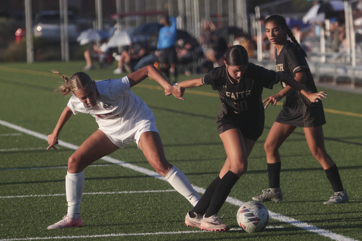 Faith Lutheran's Jordyn Staggs (30) and Coronado's Allison Kleiner (14) vie for the ball during ...