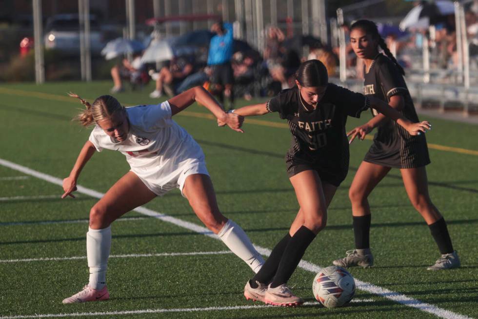 Faith Lutheran's Jordyn Staggs (30) and Coronado's Allison Kleiner (14) vie for the ball during ...