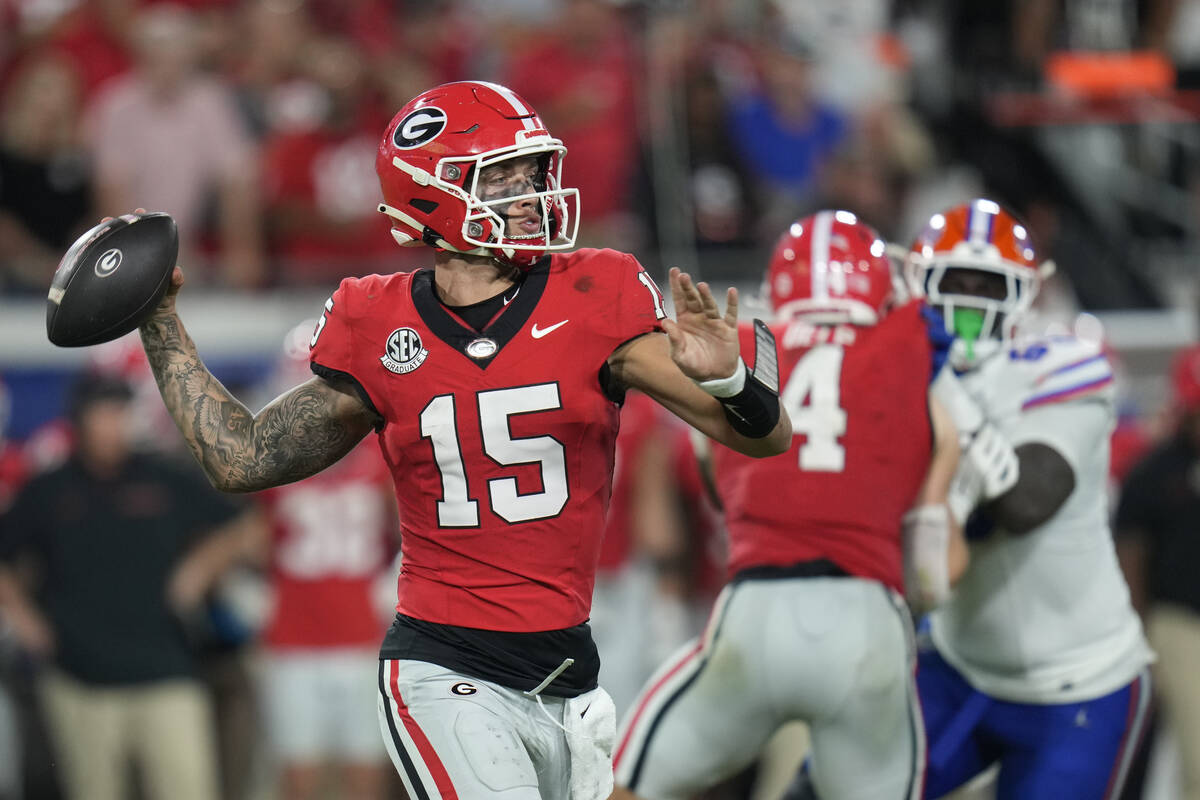 Georgia quarterback Carson Beck (15) throws a pass during the second half of an NCAA college fo ...