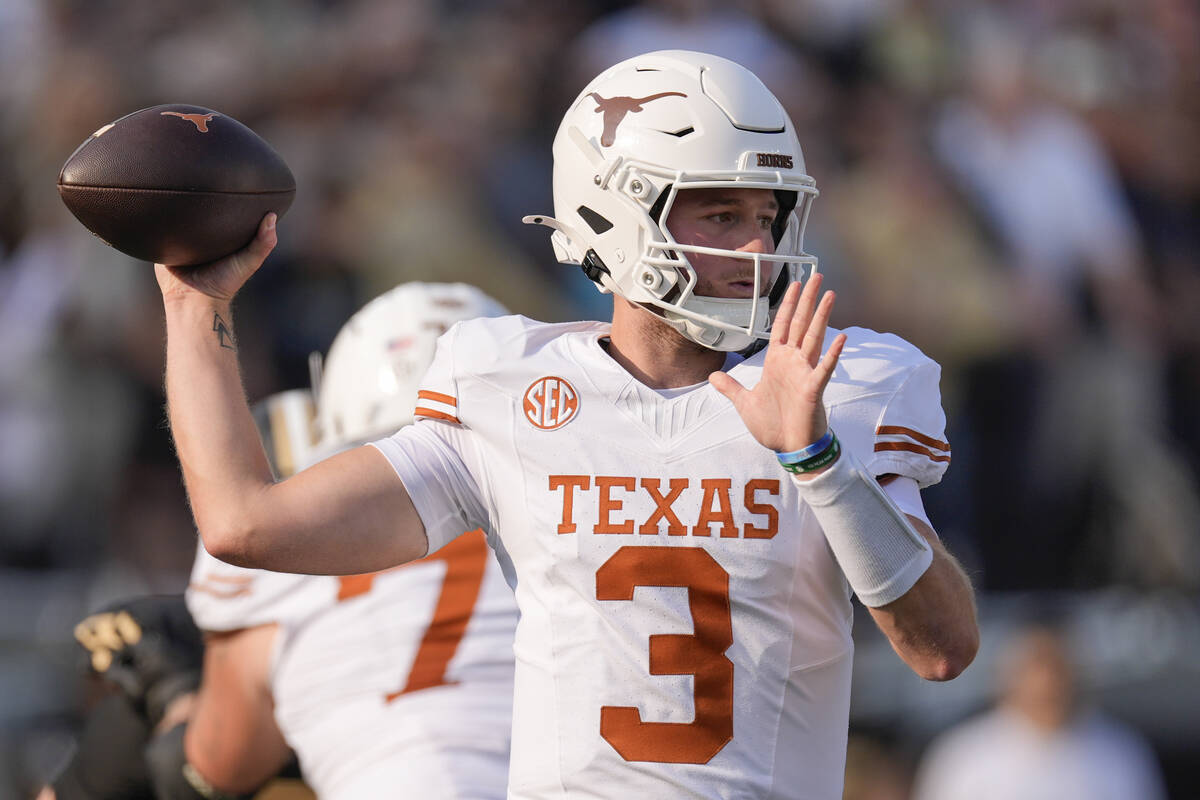 Texas quarterback Quinn Ewers (3) looks to throw a pass during the first half of an NCAA colleg ...