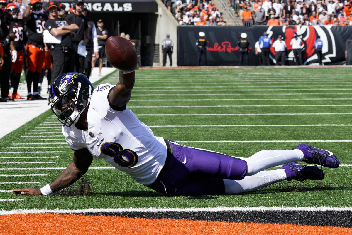 Baltimore Ravens quarterback Lamar Jackson (8) breaks a tackle by Cincinnati Bengals defensive ...