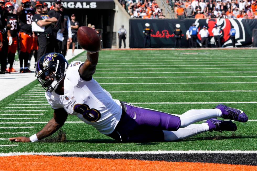 Baltimore Ravens quarterback Lamar Jackson (8) breaks a tackle by Cincinnati Bengals defensive ...