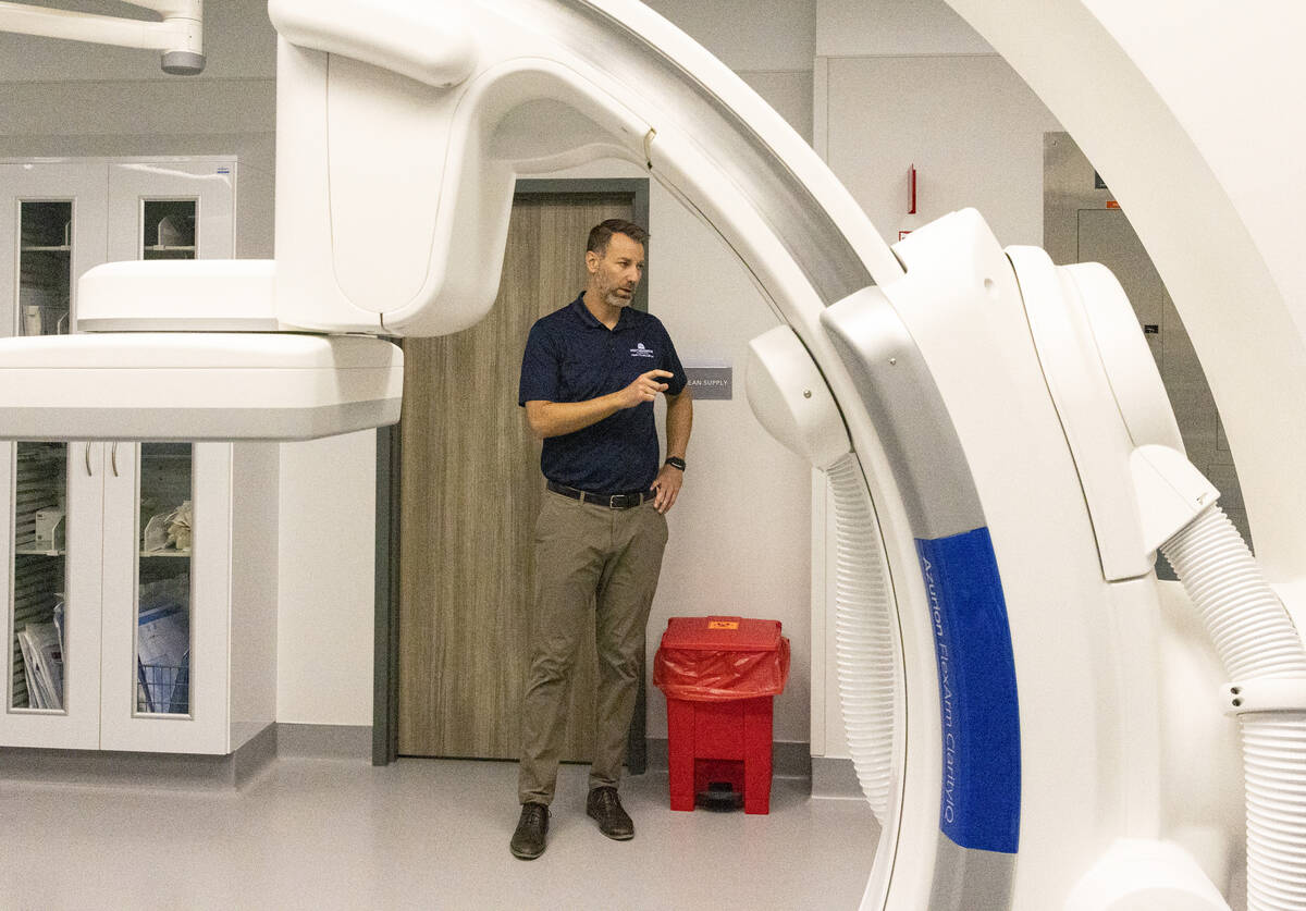 Chris Loftus, CEO of West Henderson Hospital, leads a tour the cardiac catheterization laborato ...