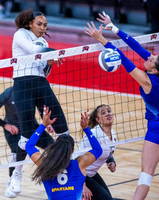 UNLV right side hitter Chloe Thomas (5) spikes the ball past the San Jose State defense during ...