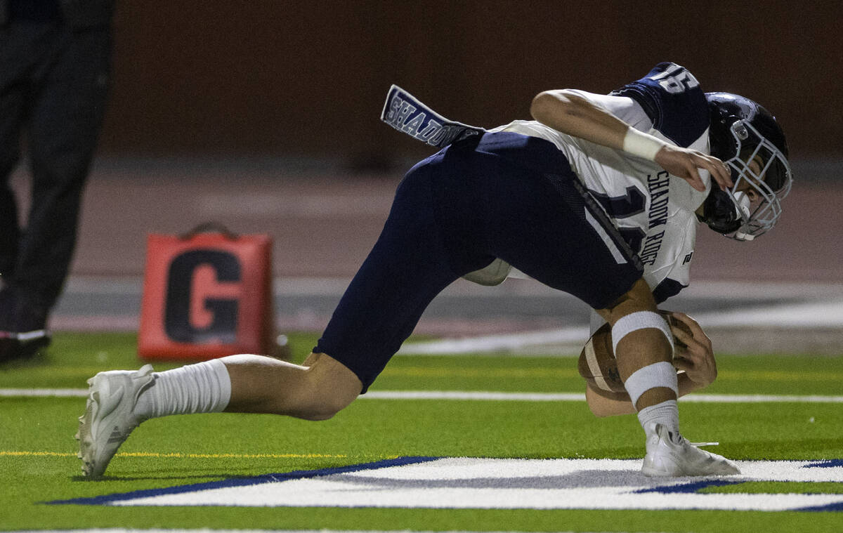 Shadow Ridge quarterback Gage Crnkovic (16)falls into the end zone for a score against Legacy d ...