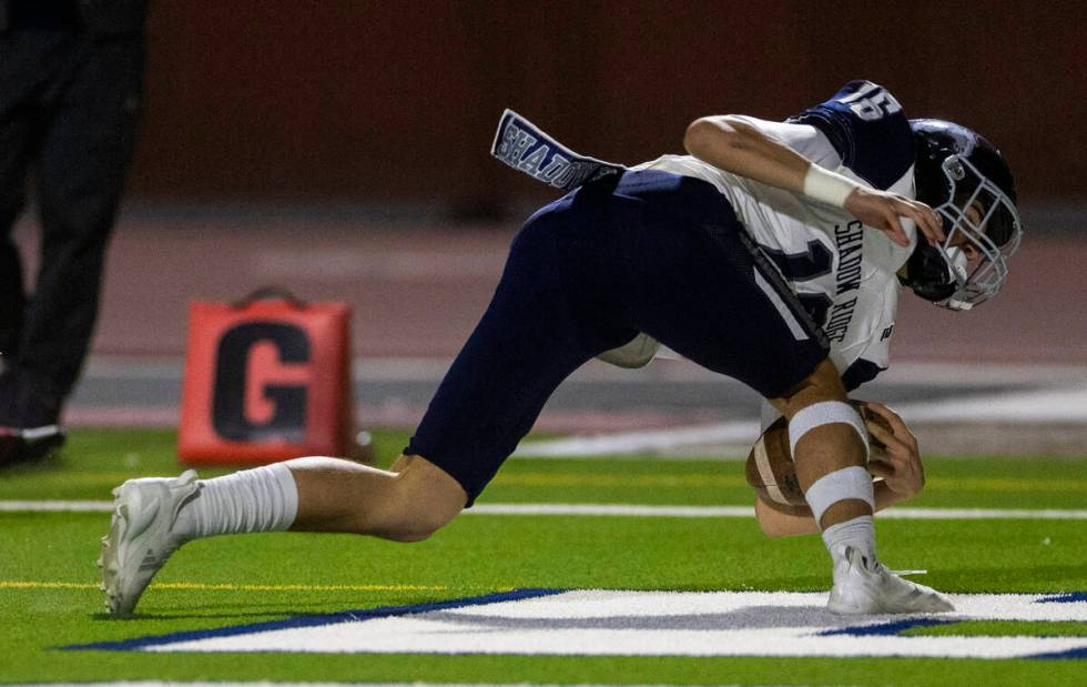 Shadow Ridge quarterback Gage Crnkovic (16)falls into the end zone for a score against Legacy d ...