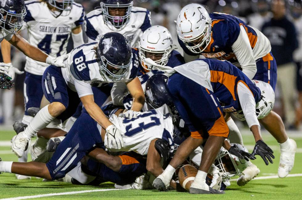 Shadow Ridge and Legacy players look to a loose ball during the first half of their Class 5A Di ...