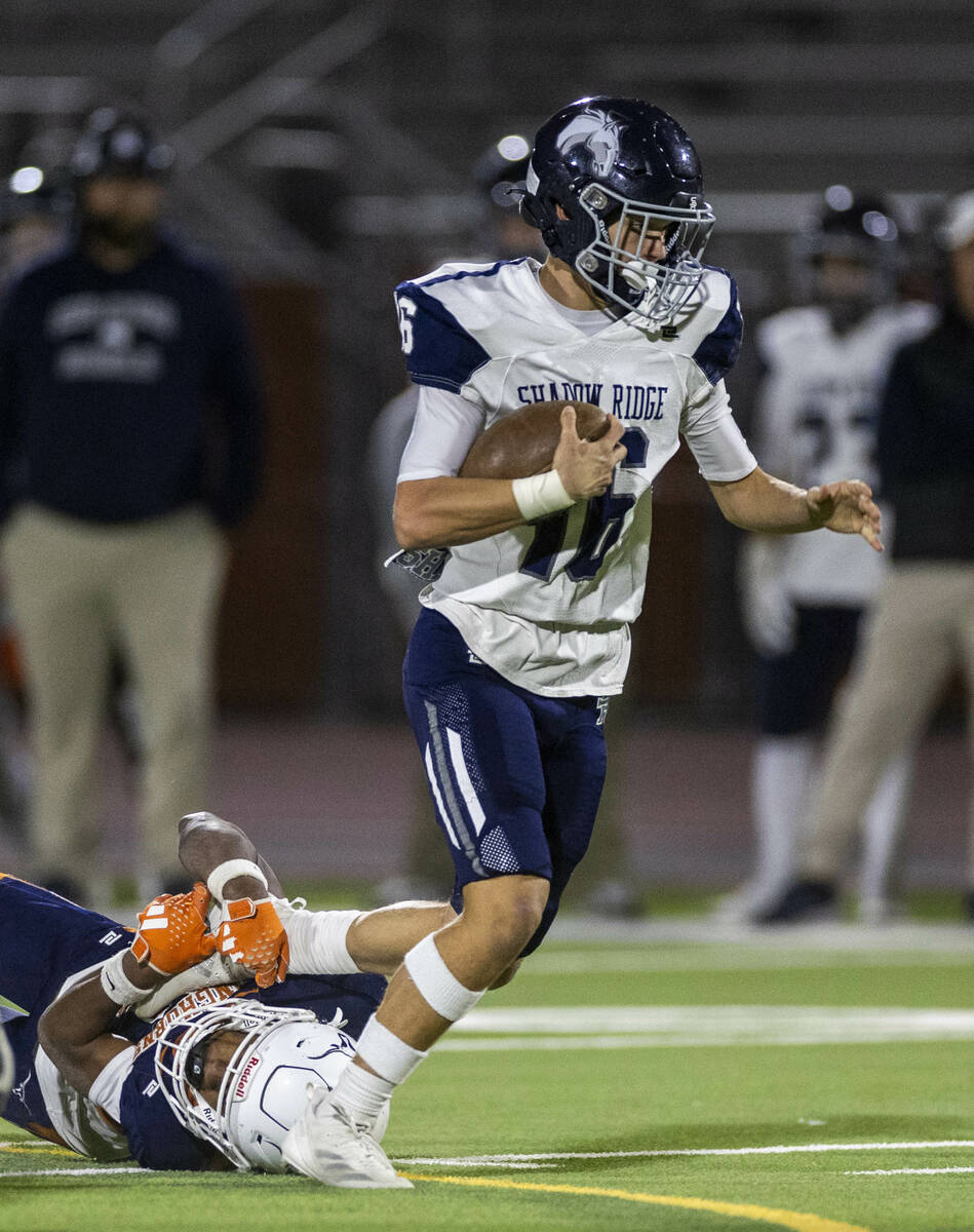 Shadow Ridge quarterback Gage Crnkovic (16) works to break a Legacy tackle attempt on a run dur ...