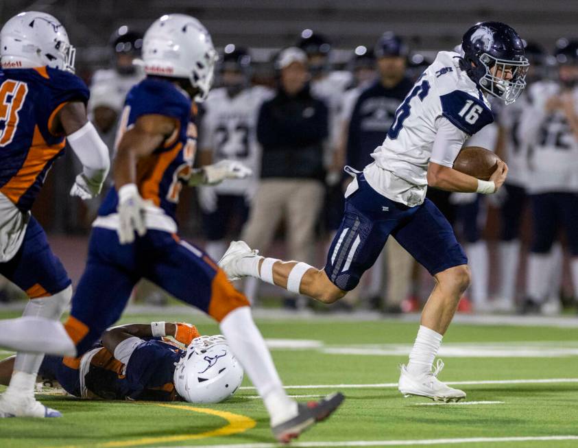 Shadow Ridge quarterback Gage Crnkovic (16) breaks a Legacy tackle attempt for a run during the ...