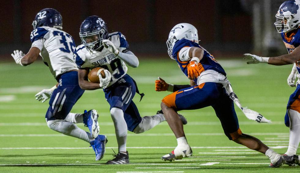 Shadow Ridge fullback Trevin Young (29) cuts past Legacy linebacker Caden Bridgewater (3) durin ...