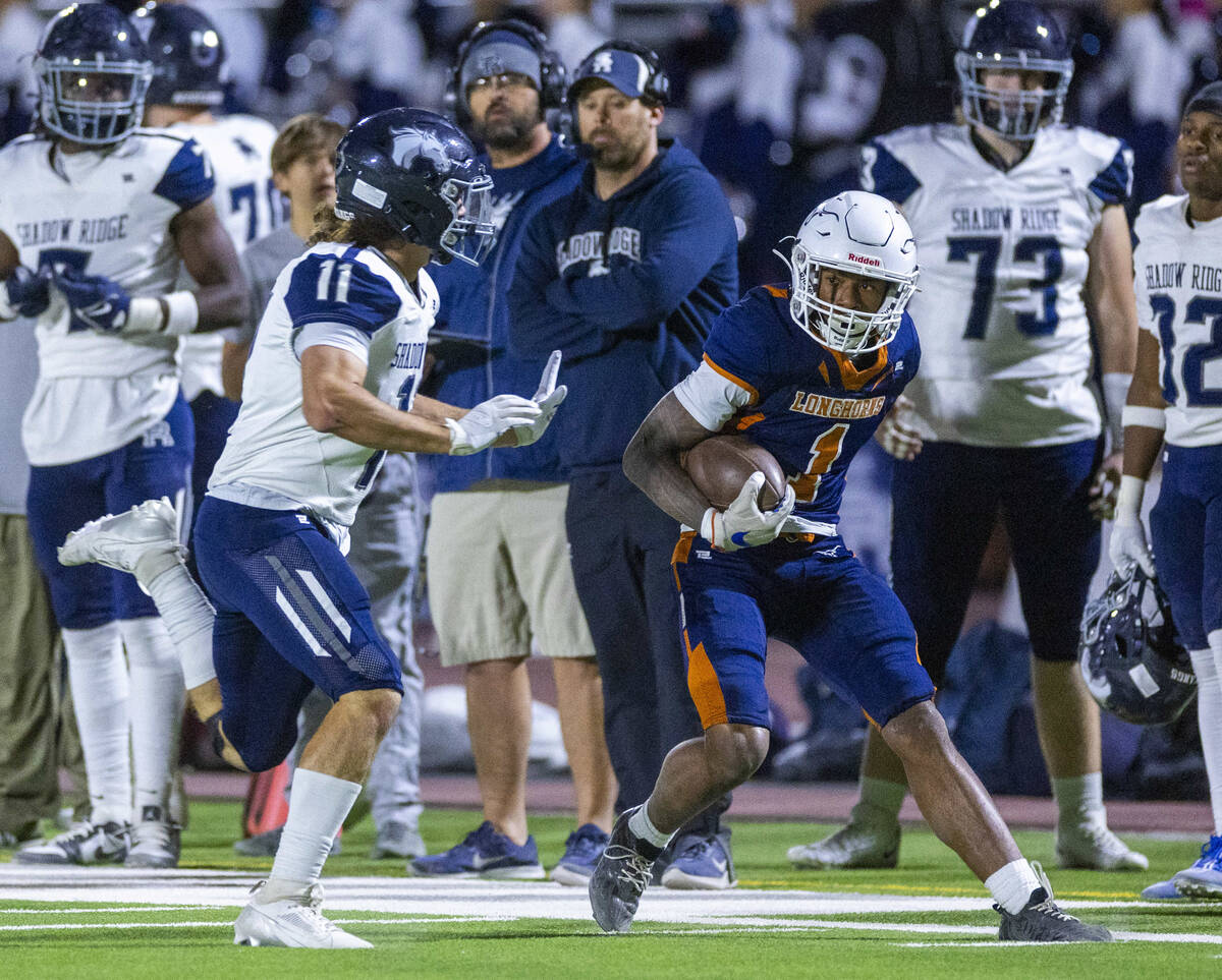 Legacy wide receiver Dominic Oliver (1) attempts to maneuver past Shadow Ridge cornerback Josep ...