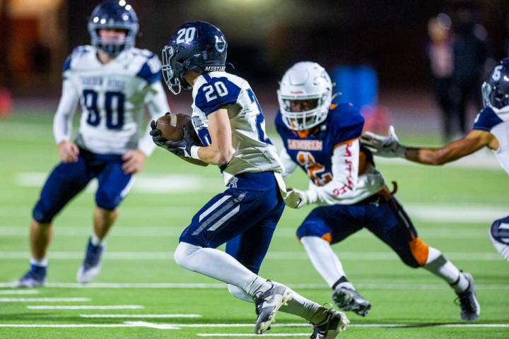 Shadow Ridge kickoff returner Hawkin Ledingham (20) evades Legacy defensive end Derric Marshall ...