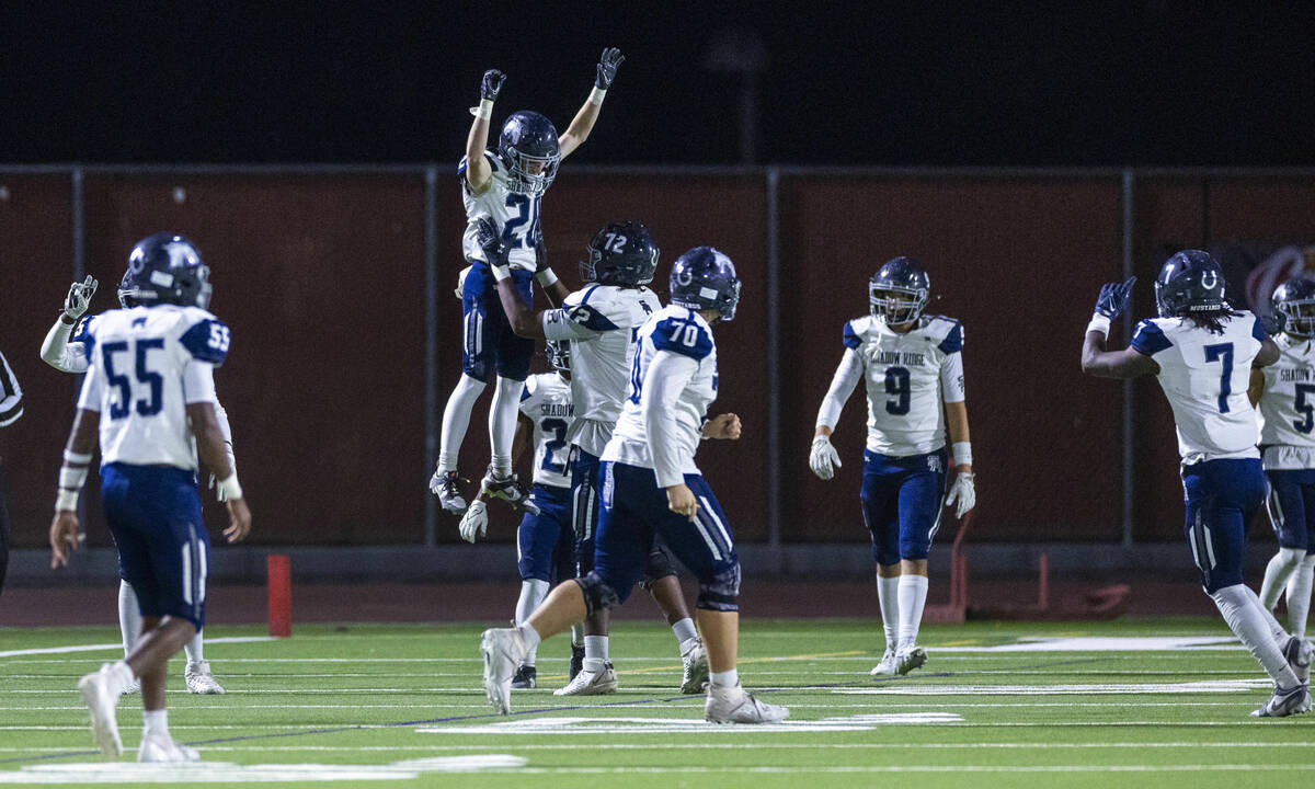 Shadow Ridge kickoff returner Hawkin Ledingham (20) is celebrated for a touchdown run by teamma ...