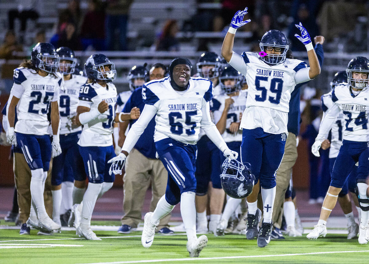 Shadow Ridge players celebrate their win over Legacy ending the second half of their Class 5A D ...