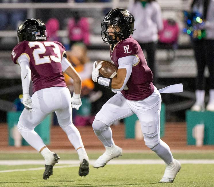 Faith Lutheran junior Rouselle Shepard, right, runs with the ball during the 5A Division II Sou ...