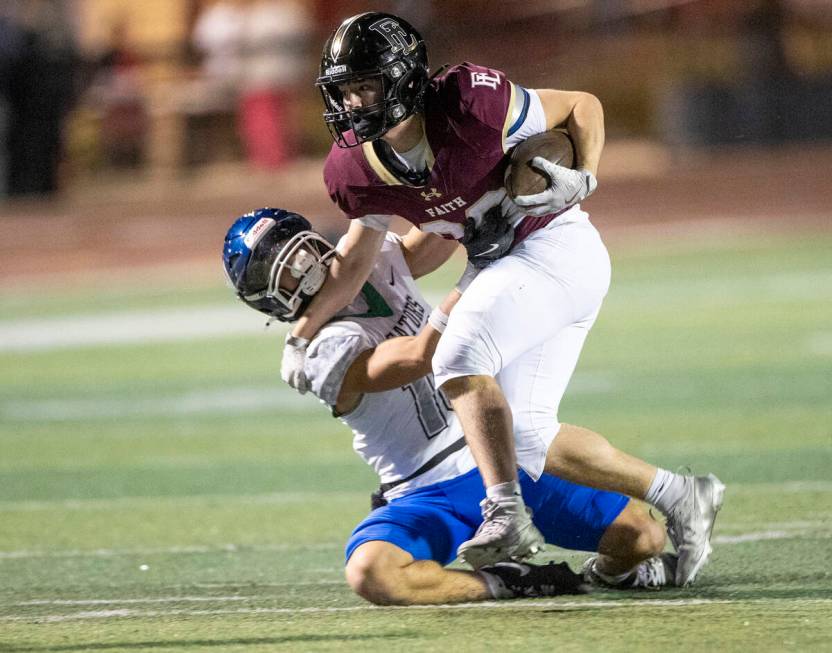 Faith Lutheran junior Justin Robbins, right, fends off Green Valley junior Roman Adams, left, d ...