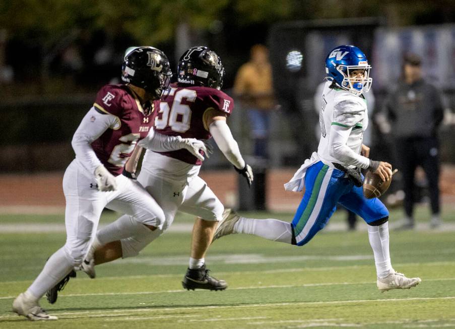 Green Valley quarterback Michael Lewis (15) runs to avoid a number of Faith Lutheran defenseman ...