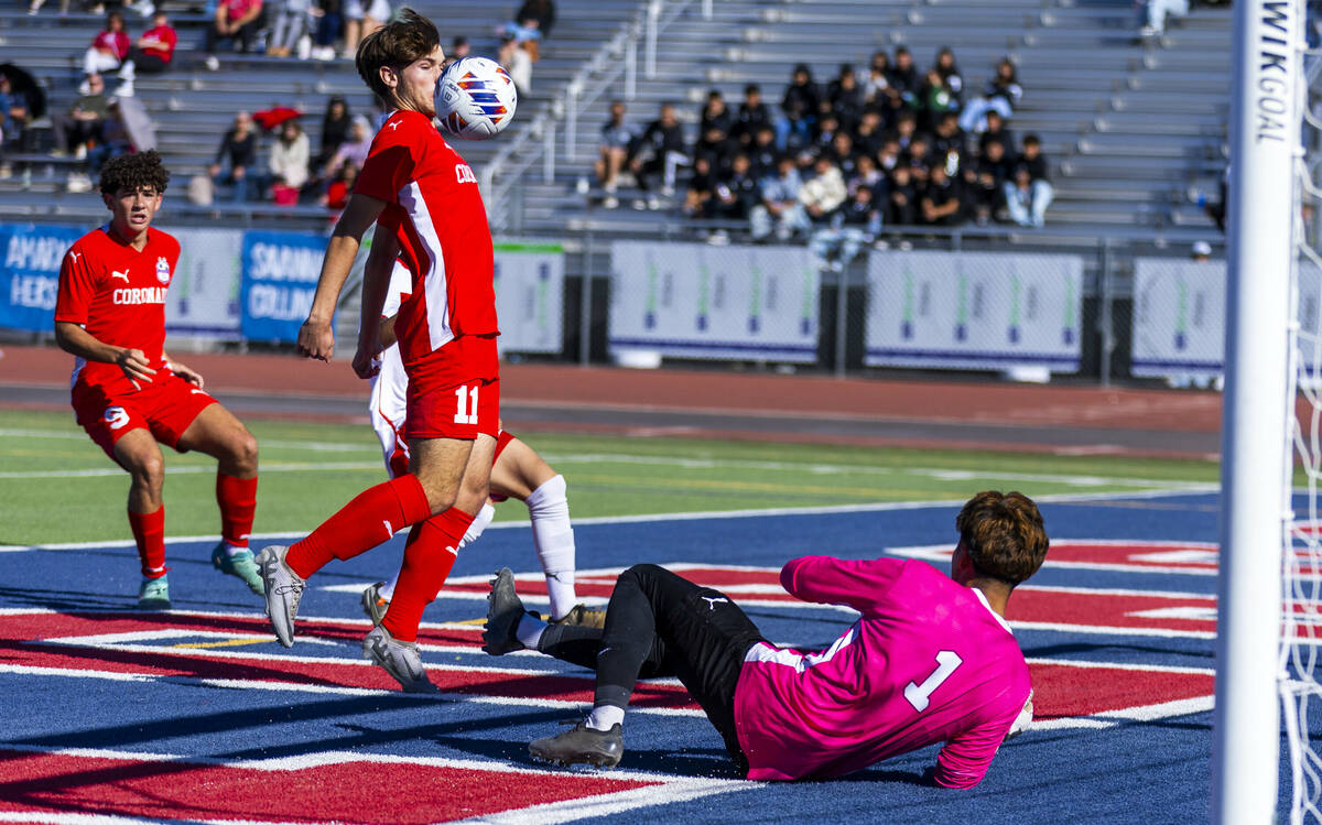 Coronado striker Gavin Flickinger (11) deflects the ball off his chest and past Wooster goalkee ...