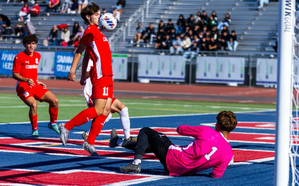 Coronado striker Gavin Flickinger (11) deflects the ball off his chest and past Wooster goalkee ...