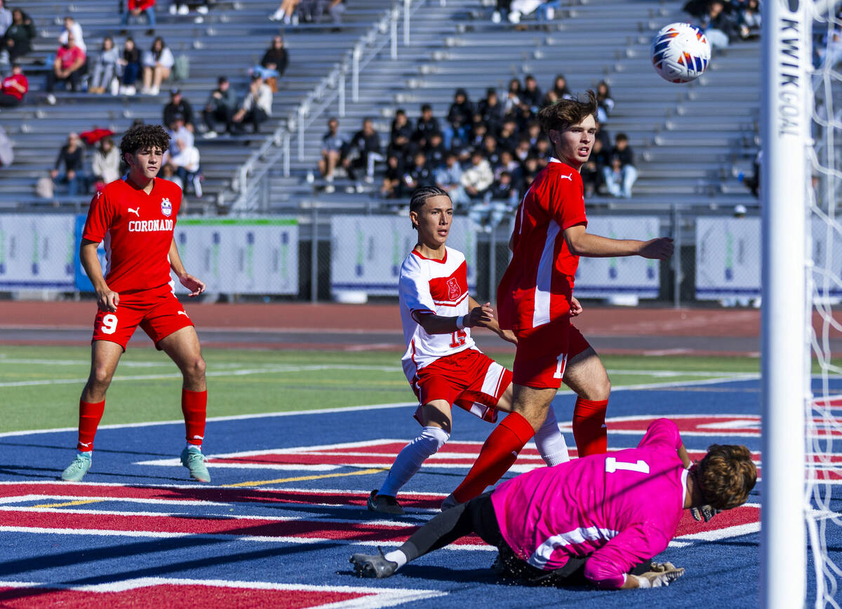 Coronado striker Gavin Flickinger (11) deflects the ball off his chest and past Wooster goalkee ...